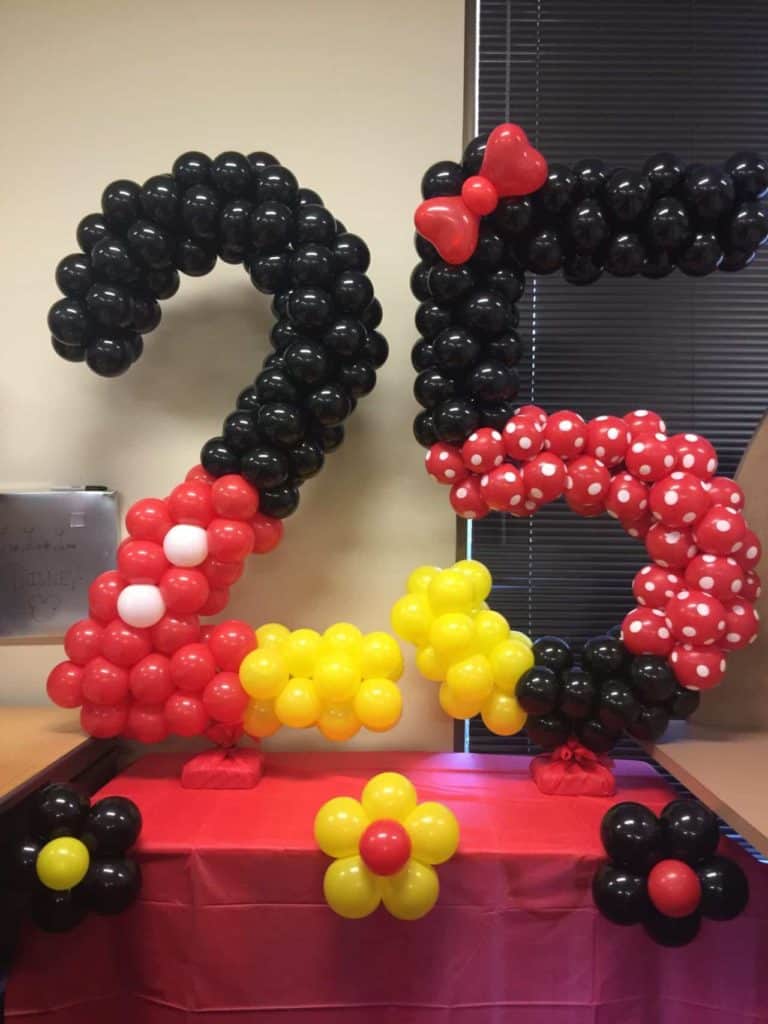 Black and red balloon numbers 25 with yellow and white balloon flowers