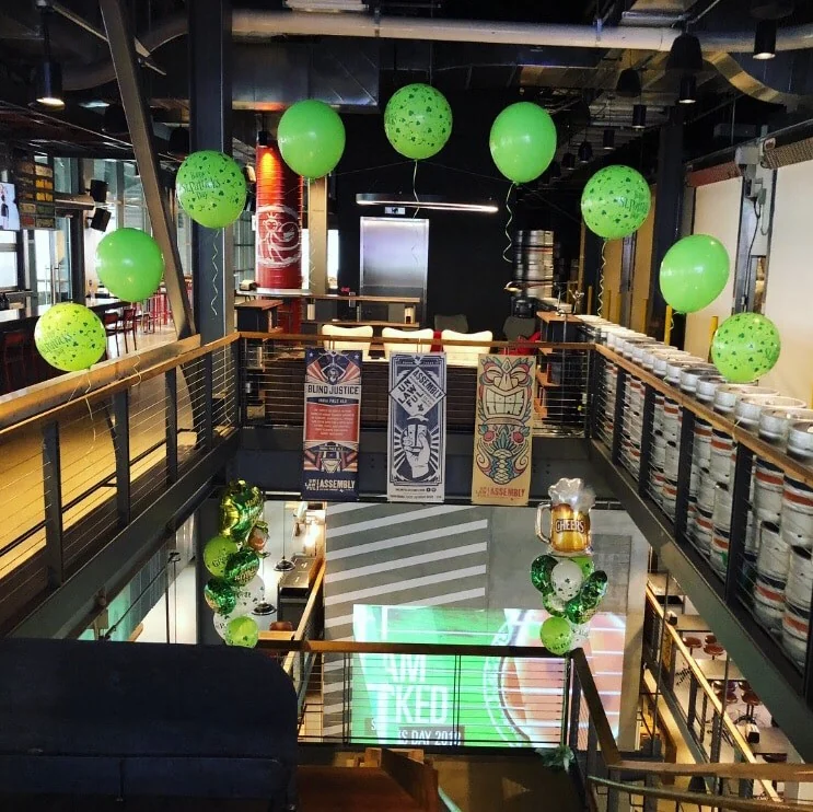 Green St. Patrick’s Day balloons decorating an indoor stairwell