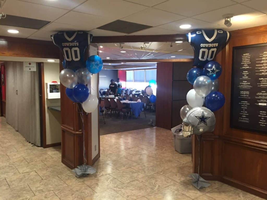 Blue and silver football-themed balloons framing a restaurant entrance