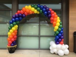 a rainbow colored balloon arch