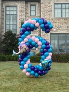 a number made of balloons in a yard