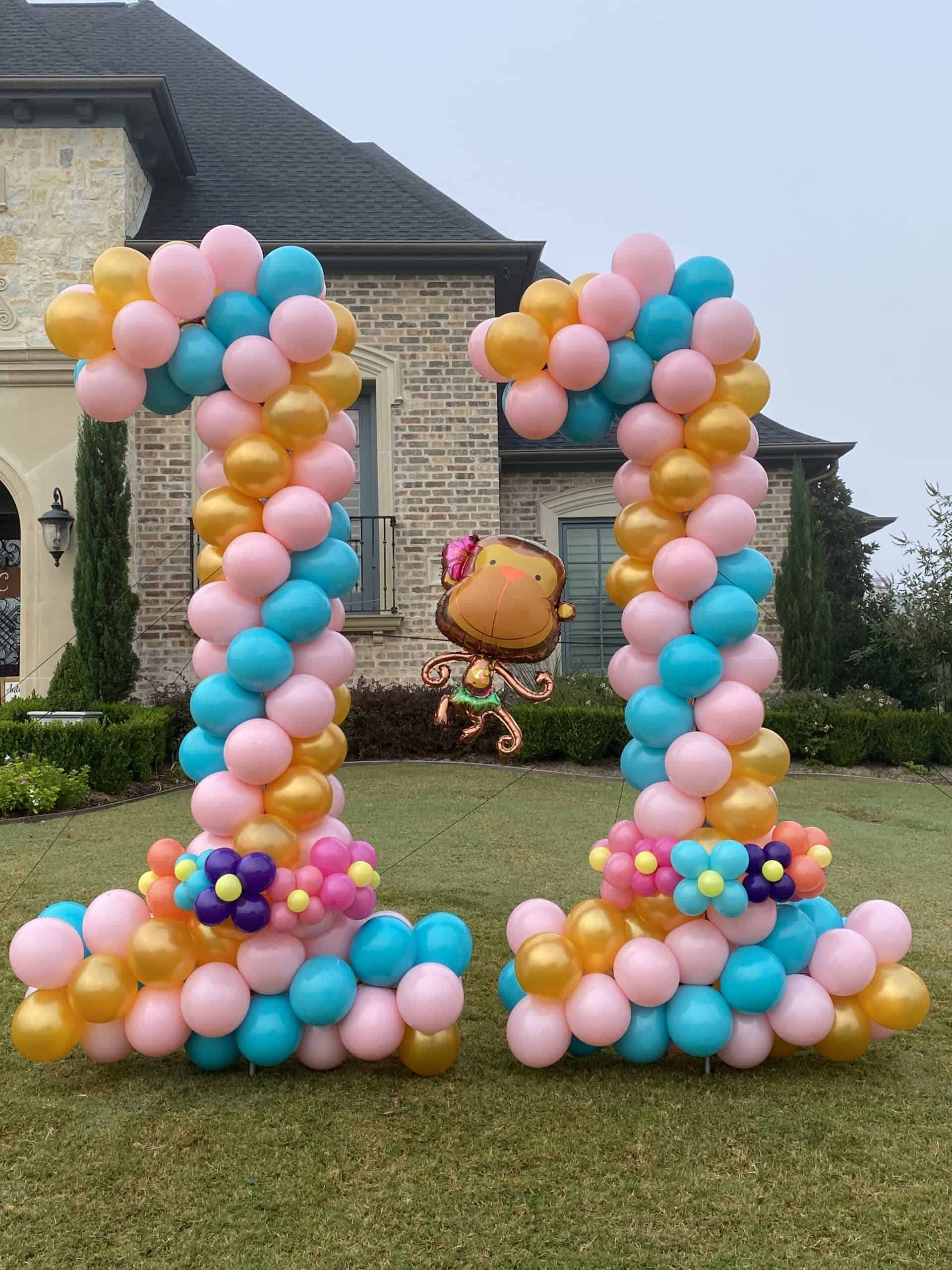 a balloon columns in front of a house