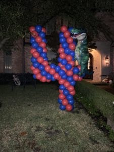 a dinosaur shaped balloon shaped number four