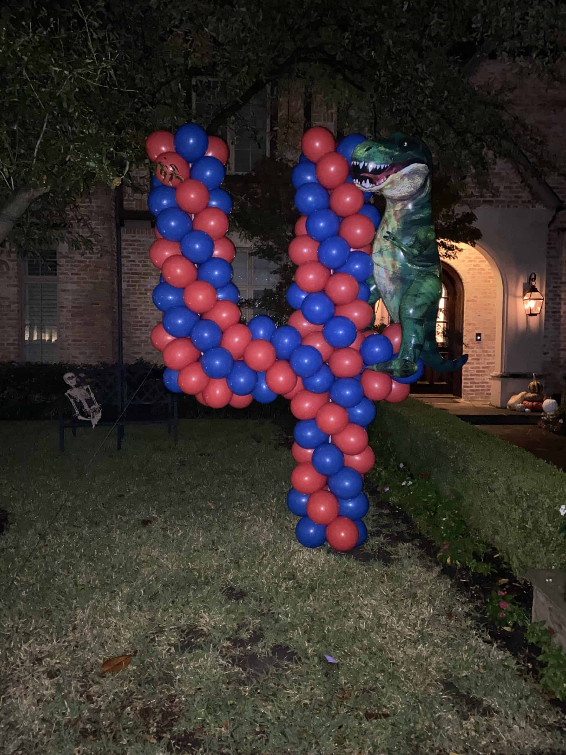 a dinosaur shaped balloon shaped number four